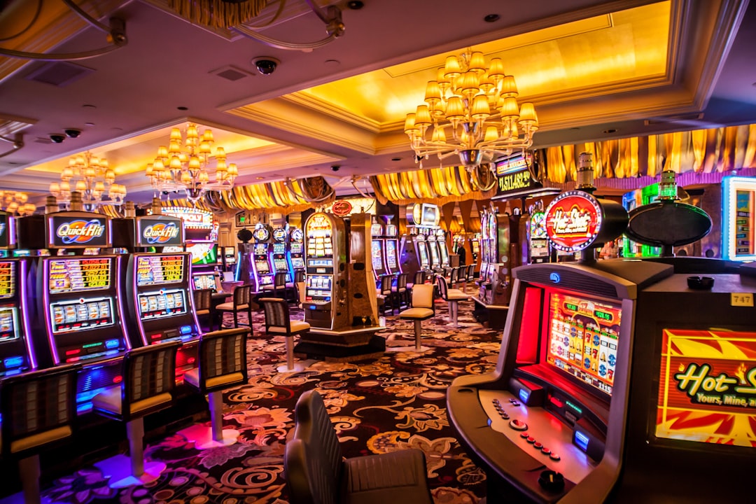 Interior view of a brightly lit casino with various slot machines